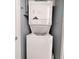 Stackable washer and dryer in a compact laundry closet at 1210 N Waccamaw Dr. # 702, Murrells Inlet, SC 29576