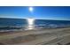 Stunning ocean view with sandy beach and clear blue sky at 1210 N Waccamaw Dr. # 702, Murrells Inlet, SC 29576