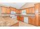 Galley kitchen featuring ample wood cabinetry and a granite countertop at 204 Atoll Dr., Myrtle Beach, SC 29588
