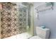 Clean bathroom with patterned shower wall, toilet, and towel rack at 211 Baslow Ct. # 2-C, Myrtle Beach, SC 29572