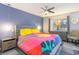 Main bedroom with yellow and gray bedding, ceiling fan, and dresser at 211 Baslow Ct. # 2-C, Myrtle Beach, SC 29572