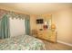 Bedroom with floral bedding, dresser, and TV at 2200 N Ocean Blvd., North Myrtle Beach, SC 29582