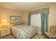 Bedroom with floral bedding and window coverings at 2200 N Ocean Blvd., North Myrtle Beach, SC 29582