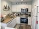Efficient kitchen with stainless steel appliances, granite countertops, and white cabinetry at 222 Westleton Dr. # 18-C, Myrtle Beach, SC 29572