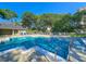 Community pool with lounge chairs and a covered seating area, surrounded by mature trees at 222 Westleton Dr. # 18-C, Myrtle Beach, SC 29572