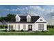 Charming single-Gathering home with a covered porch, dormer windows, and elegant black-framed windows at 2220 Pettus Way, Surfside Beach, SC 29575