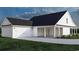 Home featuring a spacious garage, inviting porch, and verdant lawn, perfect for outdoor entertaining at 2220 Pettus Way, Surfside Beach, SC 29575