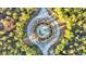 Aerial view showcasing a lush roundabout with a fountain surrounded by verdant greenery and trees at 239 Madison Dr., Georgetown, SC 29440