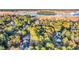 Scenic aerial view featuring homes nestled amidst mature trees near waterfront and community marina at 239 Madison Dr., Georgetown, SC 29440