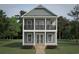 Charming two-story home with a covered porch and second-floor balcony showcasing a beautifully designed exterior at 239 Madison Dr., Georgetown, SC 29440