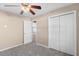 Bedroom with grey carpet, ceiling fan, and double door closet at 248 Hickory Springs Ct., Conway, SC 29527