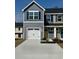 Charming two-story home with a white garage door, gray siding, and a welcoming yellow front door at 290 Myrtle Meadows Dr # 505F, Conway, SC 29526