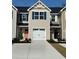 New townhome featuring a garage and colorfully painted front doors at 302 Myrtle Meadows Dr # 511B, Conway, SC 29526