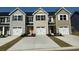 Charming townhome exterior with garages, a peaked roof, and colorful doors at 302 Myrtle Meadows Dr # 511B, Conway, SC 29526