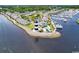 Aerial view of community with coastal homes, a marina, and a striking lighthouse, offering waterfront living at 4672 Lightkeepers Way # 50-E, Little River, SC 29566