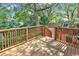 Relaxing wooden back deck overlooks lush greenery, offering a private outdoor retreat at 4672 Lightkeepers Way # 50-E, Little River, SC 29566