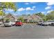 Townhome exterior with assigned parking spaces, inviting landscaping, and classic architectural details at 4672 Lightkeepers Way # 50-E, Little River, SC 29566