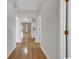 Inviting hallway with hardwood floors, neutral paint, and multiple doorways leading to other rooms at 4672 Lightkeepers Way # 50-E, Little River, SC 29566