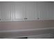 Close-up of kitchen cabinets and countertop, showcasing white cabinets and outlets at 4672 Lightkeepers Way # 50-E, Little River, SC 29566