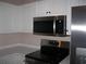 Modern kitchen with stainless steel appliances, white cabinets, and sleek countertops at 4672 Lightkeepers Way # 50-E, Little River, SC 29566