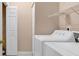 Functional laundry room with a washer, dryer, shelving, and a closet for storage at 4672 Lightkeepers Way # 50-E, Little River, SC 29566