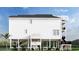 Two-story home with white siding, black accents, and a side entrance at 48 Furman Ln., Pawleys Island, SC 29585