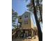 Two-story house under construction, elevated on stilts with light blue and tan siding at 48 Furman Ln., Pawleys Island, SC 29585