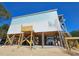 Elevated two-story house under construction, with light blue and white siding at 48 Furman Ln., Pawleys Island, SC 29585