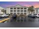 Exterior view of building at sunset with parking at 5010 Windsor Green Way # 301, Myrtle Beach, SC 29579