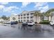 Condo building with parking lot and palm trees; great location at 5010 Windsor Green Way # 301, Myrtle Beach, SC 29579