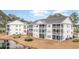 Condo building with pond and screened balconies at 5010 Windsor Green Way # 301, Myrtle Beach, SC 29579