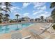 Community swimming pool with plenty of lounge chairs at 5010 Windsor Green Way # 301, Myrtle Beach, SC 29579