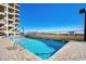 Relaxing pool area with nearby building and ocean view at 517 S Ocean Blvd. # 105, North Myrtle Beach, SC 29582