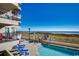 Inviting pool area with ocean views, patio furniture and nearby building at 517 S Ocean Blvd. # 105, North Myrtle Beach, SC 29582