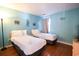 Bedroom with two twin beds and light blue walls at 517 White River Ct. # 22A, Myrtle Beach, SC 29579