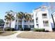White building with palm trees and a sidewalk at 517 White River Ct. # 22A, Myrtle Beach, SC 29579