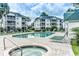 Community pool and hot tub with lounge chairs at 517 White River Ct. # 22A, Myrtle Beach, SC 29579