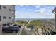 View of beach access from the property, showing parking and pathway at 5709 N Ocean Blvd. N # 202, North Myrtle Beach, SC 29582