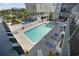 Community pool with lounge chairs at 5709 N Ocean Blvd. N # 202, North Myrtle Beach, SC 29582
