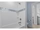 Bathroom with white wave patterned tile and built-in shower at 6001 South Kings Hwy., Myrtle Beach, SC 29575