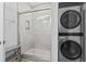 Bathroom with a walk-in shower and stackable washer/dryer at 6001 South Kings Hwy., Myrtle Beach, SC 29575