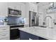 Modern kitchen features stainless steel appliances and blue tile backsplash at 6001 South Kings Hwy., Myrtle Beach, SC 29575