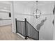 Modern staircase with black metal railing and globe light fixture at 6001 South Kings Hwy., Myrtle Beach, SC 29575