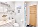 Bright bathroom with a white vanity, decorative nautical accents, and a shower behind a blue-striped curtain at 6001-Z16 S Kings Hwy., Myrtle Beach, SC 29575