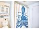 Nautical-themed bathroom featuring an octopus shower curtain, white cabinets, and beach-inspired accents for a coastal feel at 6001-Z16 S Kings Hwy., Myrtle Beach, SC 29575