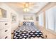 Cozy bedroom features a whale-patterned quilt, white furniture, and a ceiling fan, creating a relaxing coastal theme at 6001-Z16 S Kings Hwy., Myrtle Beach, SC 29575
