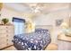 Comfortable bedroom with blue patterned bedding, light dresser, and neutral walls at 6001-Z16 S Kings Hwy., Myrtle Beach, SC 29575