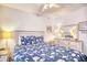 Well-lit bedroom with blue patterned bedding, light dresser, and ceiling fan at 6001-Z16 S Kings Hwy., Myrtle Beach, SC 29575