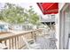 Inviting outdoor deck with wicker furniture, potted plants, and a red awning offers a cozy spot for outdoor enjoyment at 6001-Z16 S Kings Hwy., Myrtle Beach, SC 29575