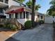 Charming home with red awning, wooden deck, driveway, and manicured bushes at 6001-Z16 S Kings Hwy., Myrtle Beach, SC 29575